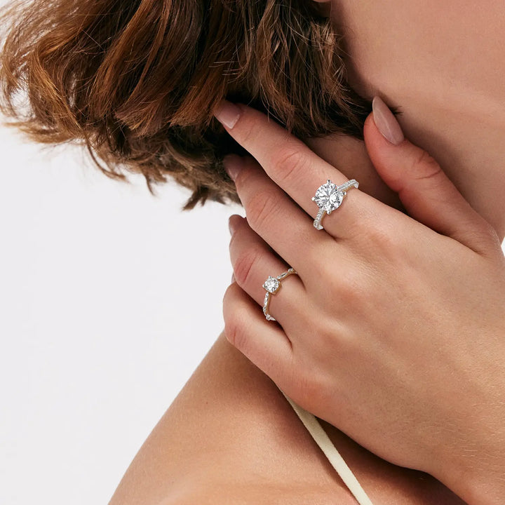 0.5 and 3.5 carats round cut moissanite diamond rings worn on hand