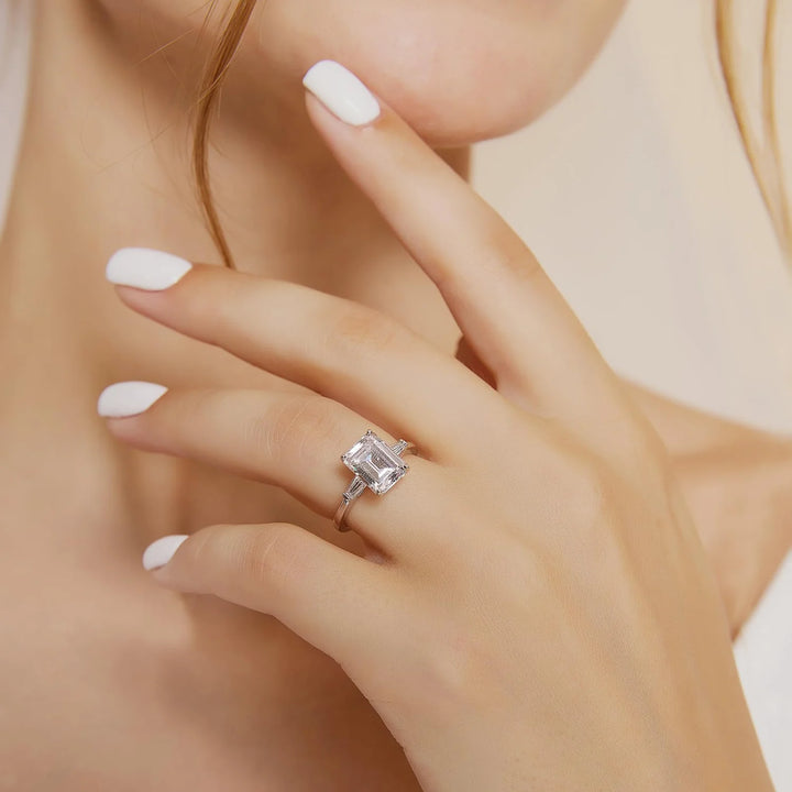 3 carats three stone engagement ring on hand