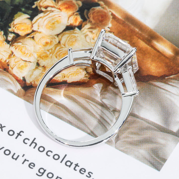 Side view of classic 5ct emerald moissanite engagement rings