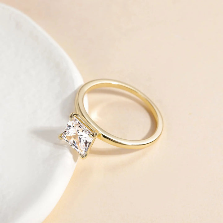 Side view of affordable gold princess engagement rings with moissanite