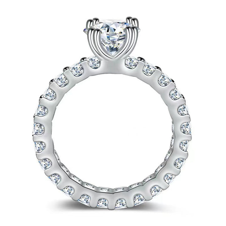 Side view of affordable moissanite wedding ring with paired prong eternity band