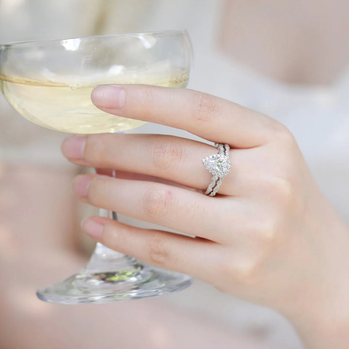 Classic 1.5 carat pear moissanite bridal sets worn on hand