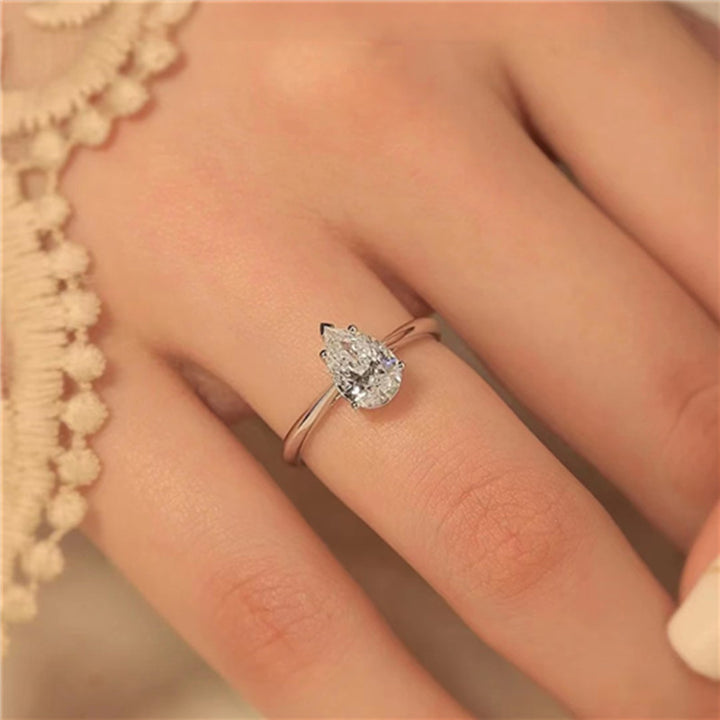 pear cut solitaire engagement ring worn on hand