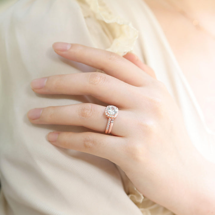 Rose 1.2ct moissanite bridal sets with halo engagement ring and half pave band worn on hand
