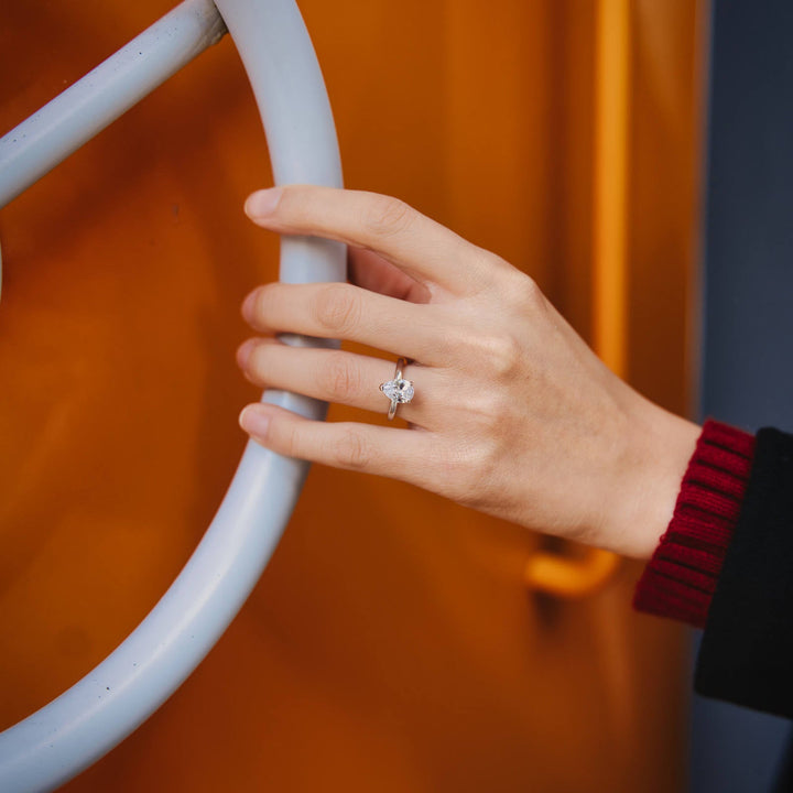 2 carats pear moissanite engagement ring worn on hand