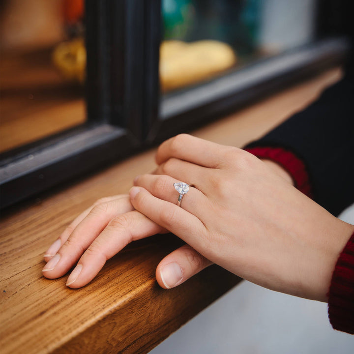 Beautiful 2 carats pear cut engagement ring with  moissanite worn on hand